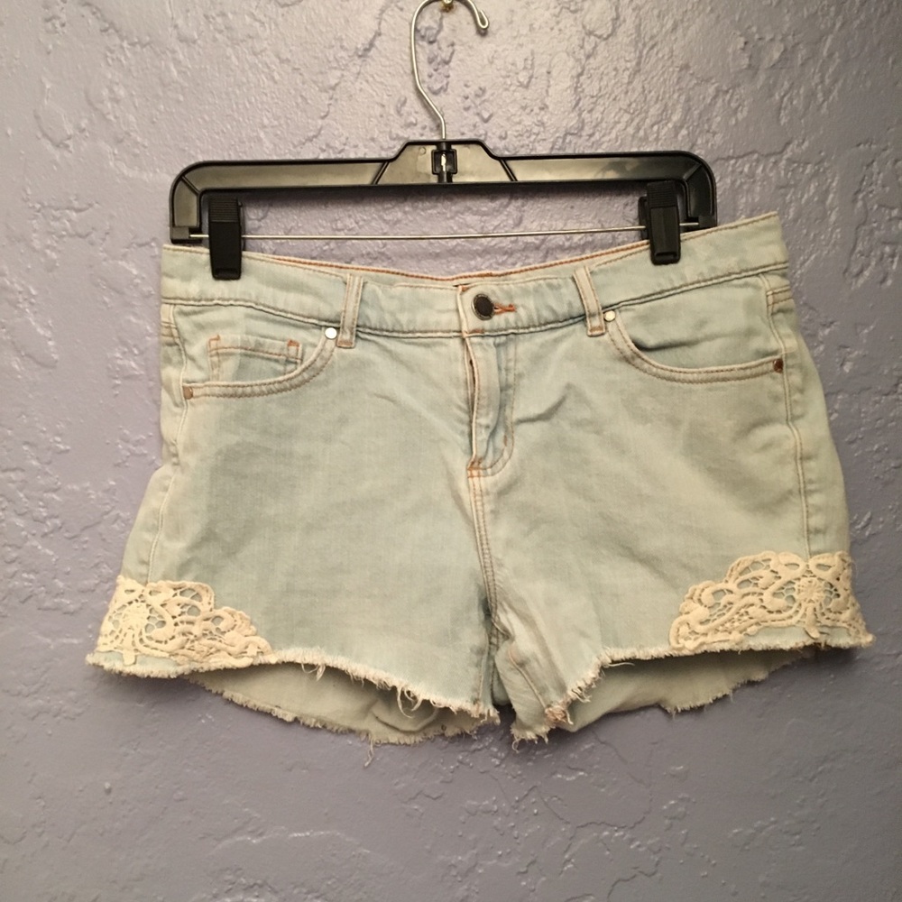 Light denim jean shorts with cream lace details